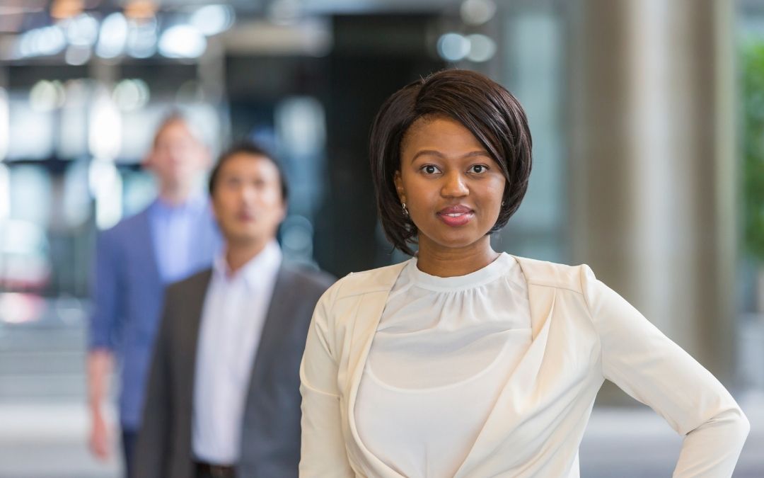 Black woman in leadership position in front of a line of men
