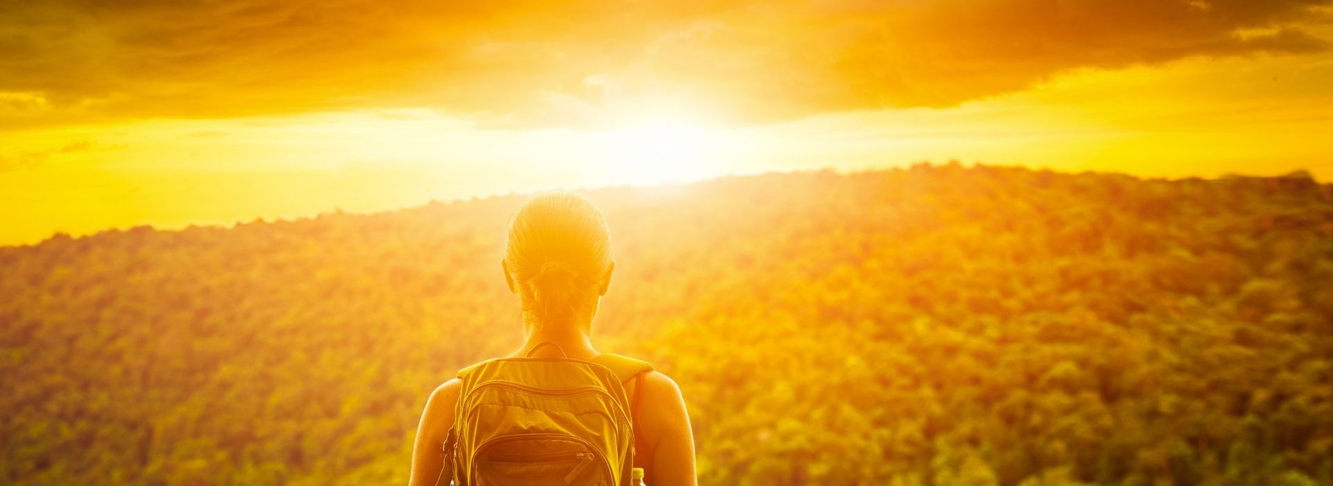 Purposeful-Living-Header Woman looking at sunset and feeling purposeful