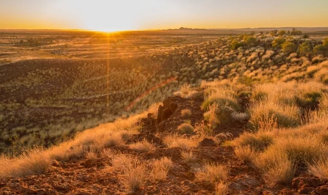 Australian outback sunrise landscape, warm golden tones and open sky