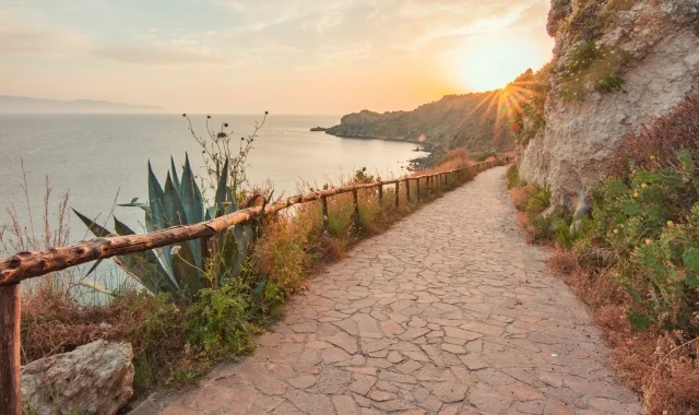 image of path alongside coastal hill leading toward the sunset representing one-to-one retreat experience mobile version