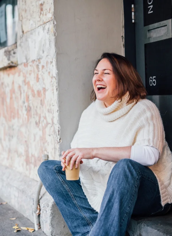 women in business hub sonya stattmann sonya stattmann sitting on kerb with coffee in hand, laughing