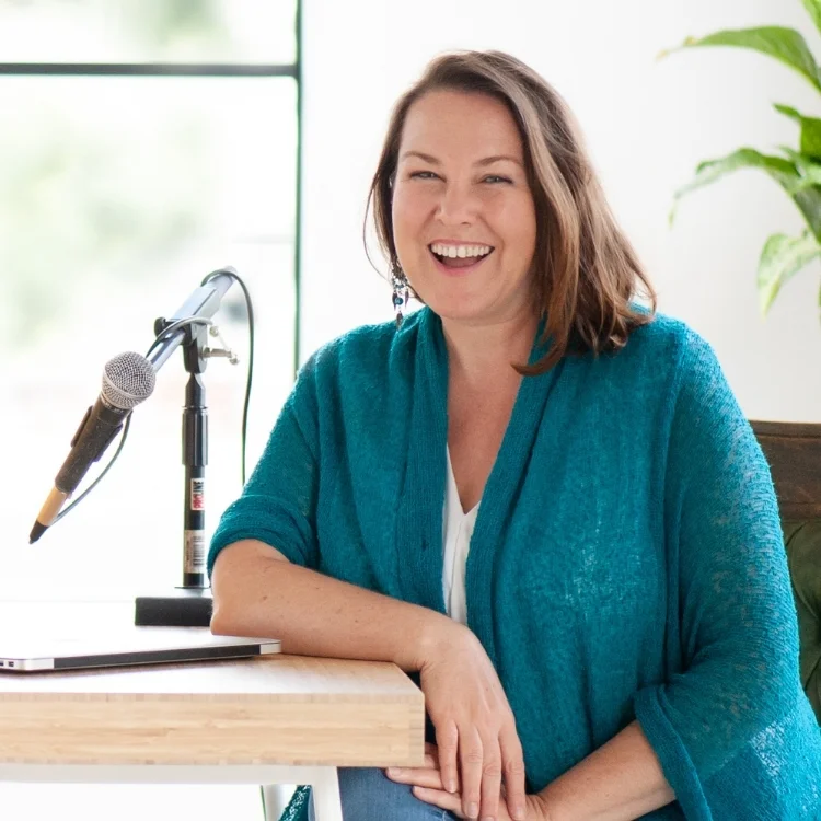 image of Sonya Stattmann at a microphone, host of Women in the Business Arena and creator of Burnout Recovery Roadmap